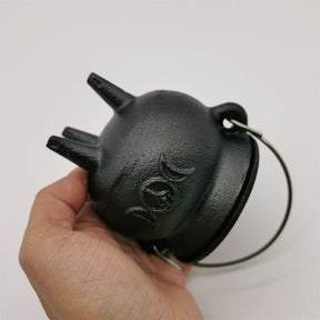 Cast iron cauldron side held for scale