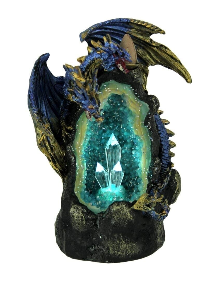 Two blue dragons with gold-tone wings surround a dark cave incense burner, with a glowing turquoise crystal-style interior and pointed formations.