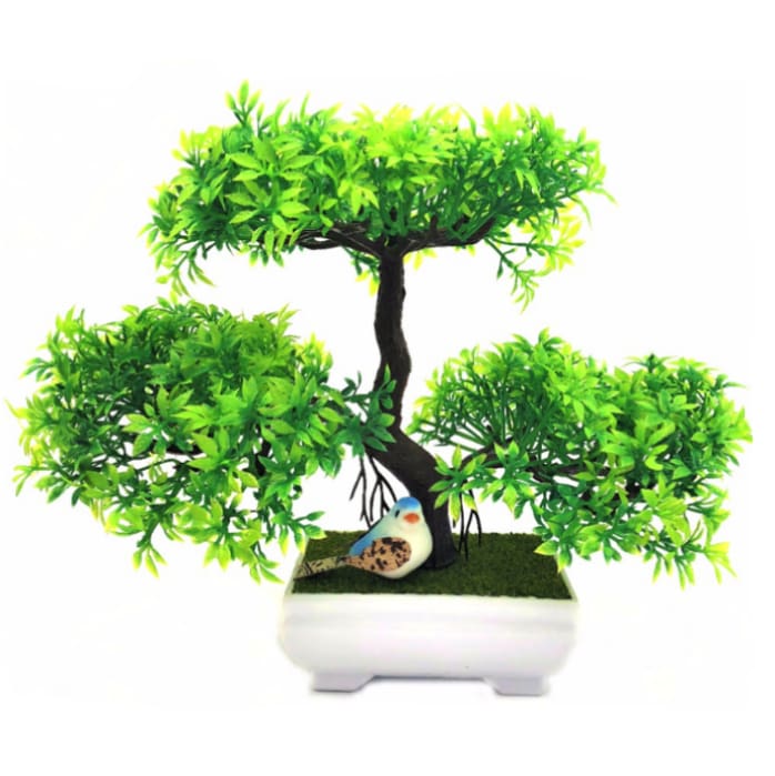 Green artificial bonsai tree with three foliage clusters, a dark branching trunk, green decorative base and white footed pot.