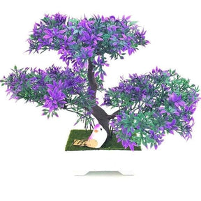 Purple-tipped artificial bonsai tree with green leaves, three rounded foliage clusters and a white rectangular pot.