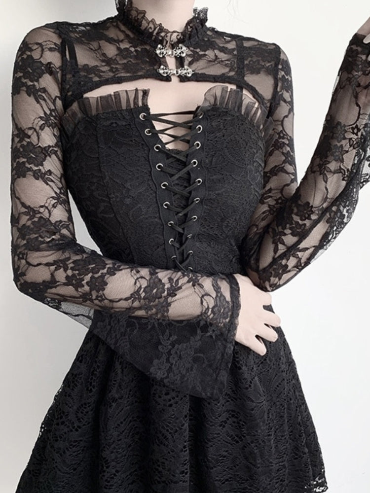Black floral lace bolero worn over a separate lace-up dress. A ruffled high collar and two ornate silver-tone clasps frame the neckline while the model raises one arm.