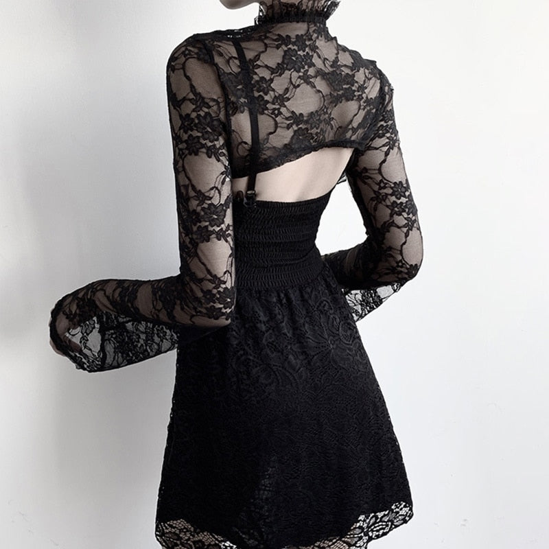 Rear view of the cropped black floral lace bolero over a separate dress, showing the high ruffled collar and short back hem above an open section.