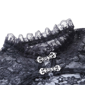 Detail of the black lace bolero's ruffled high neckline and two ornate silver-tone clasps, with the floral pattern visible behind the hardware.