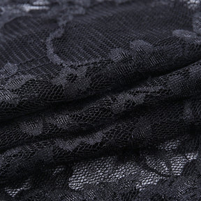 Close-up of the black floral lace fabric, with raised-looking flower and leaf patterns spread across a fine net background.