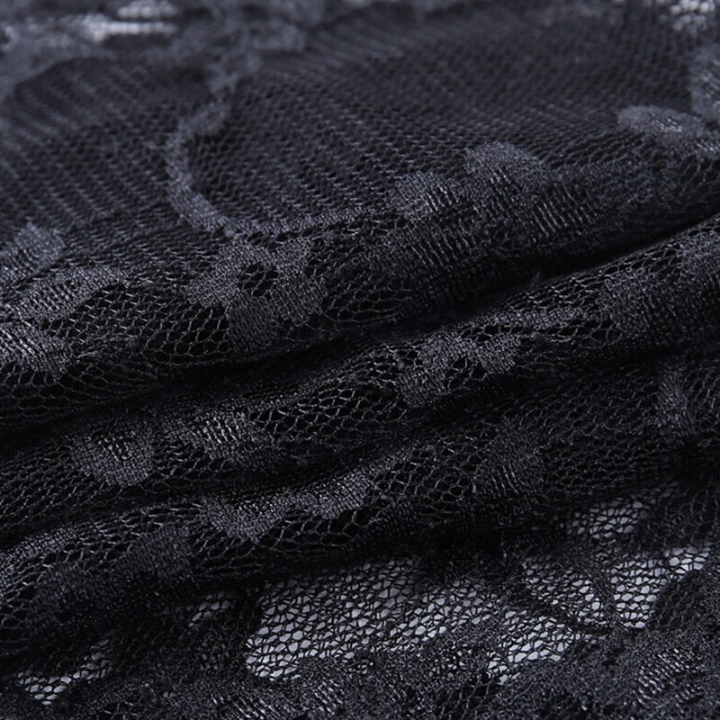 Close-up of the black floral lace fabric, with raised-looking flower and leaf patterns spread across a fine net background.