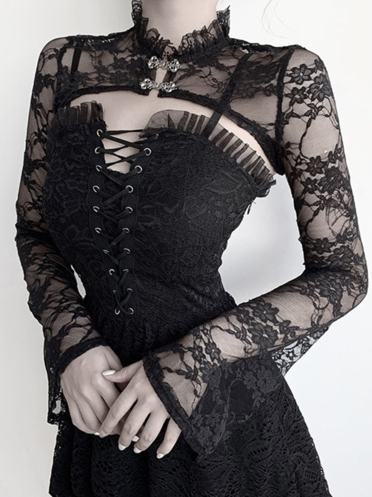 Front view of the Victorian lace overlay over a black corset-style dress, with hands folded at the waist. The fitted sleeves flare gently at the cuffs.
