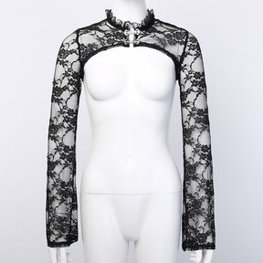 Front view of the sheer black floral lace overlay on a white mannequin, with two ornate clasps beneath the ruffled collar and an open cropped body.