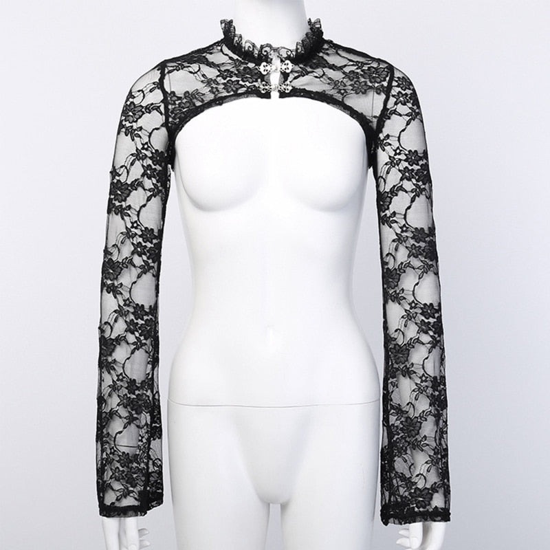 Front view of the sheer black floral lace overlay on a white mannequin, with two ornate clasps beneath the ruffled collar and an open cropped body.