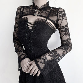 Black Victorian-inspired lace bolero styled over a lace-up black dress, displaying the sheer floral sleeves, cropped front and decorative clasps.