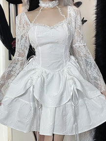 Front view of the white Dark Chapel mini dress on a model, showing the fitted bodice, lace choker and long bell sleeves above a layered skirt with ribbon ties.