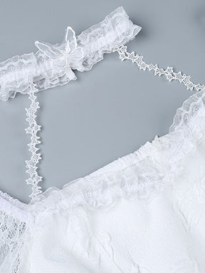 Close view of the white lace choker, star-patterned connecting straps and scalloped neckline on the butterfly-textured dress.