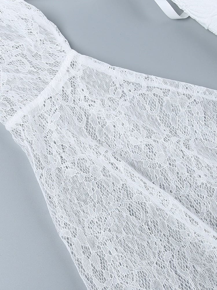 White floral lace bell sleeve laid flat, showing its open pattern, flared shape and scalloped cuff edge.