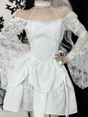 The white dress styled with lace sleeves below the shoulders and one hand at the hip. Star-patterned straps link the neckline to the choker above the fitted bodice.