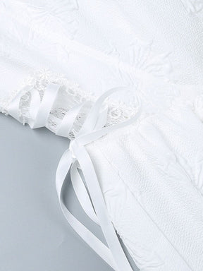 White ribbon threaded in crisscross lacing over a floral lace side panel on the dress, bordered by butterfly-textured fabric.