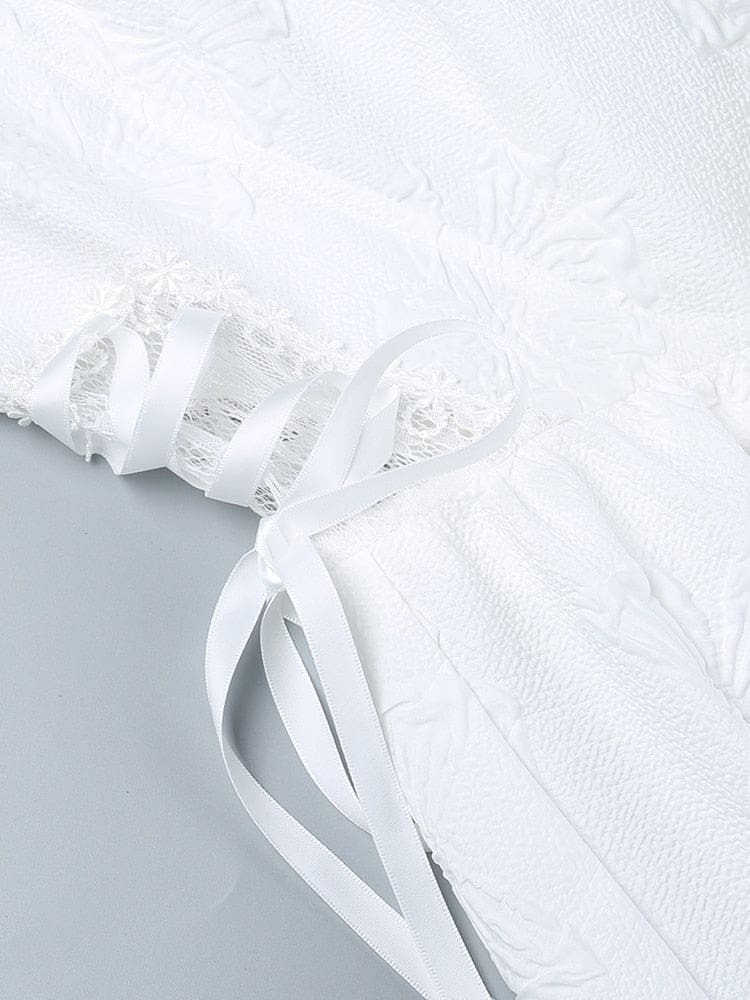 White ribbon threaded in crisscross lacing over a floral lace side panel on the dress, bordered by butterfly-textured fabric.