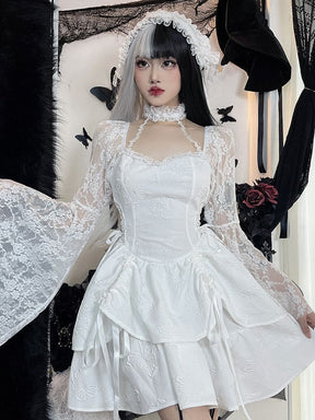 White gothic mini dress modeled with one arm extended to display a wide floral lace bell sleeve. The choker and gathered butterfly skirt complete the outfit.