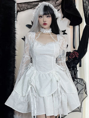 Full outfit view of the white butterfly mini dress with the model's arms lowered, showing the fitted bodice, long lace sleeves and short layered hem.
