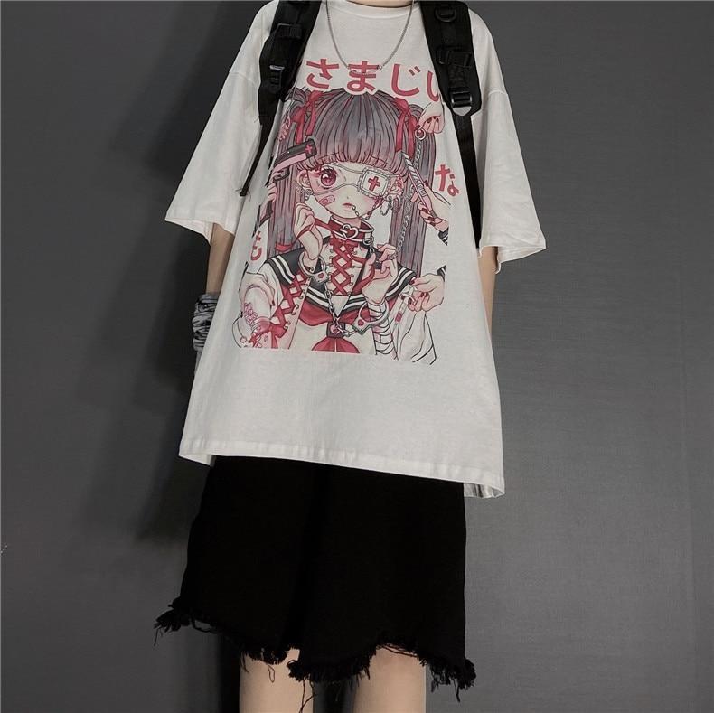 White dark kawaii T-shirt worn with black backpack straps and frayed black shorts. The large anime girl print fills the front beneath a round neckline.