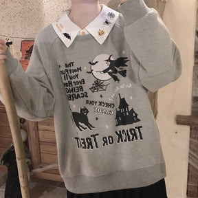 Halloween blouse collar layered over a gray Trick or Treat sweatshirt in a mirror outfit, with embroidered pumpkins, bats and spiderwebs at the neckline.