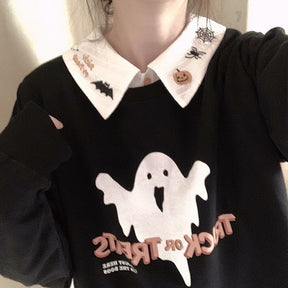 White embroidered collar styled over a black sweatshirt with a large white ghost graphic, showing both pointed collar tips.
