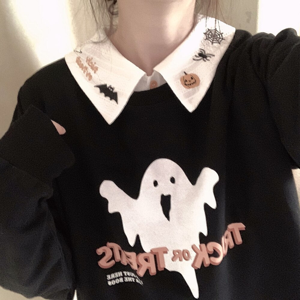 White embroidered collar styled over a black sweatshirt with a large white ghost graphic, showing both pointed collar tips.