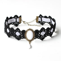 Black lace choker with an ornate oval centerpiece and hanging teardrop in the White ribbon and jewel option.