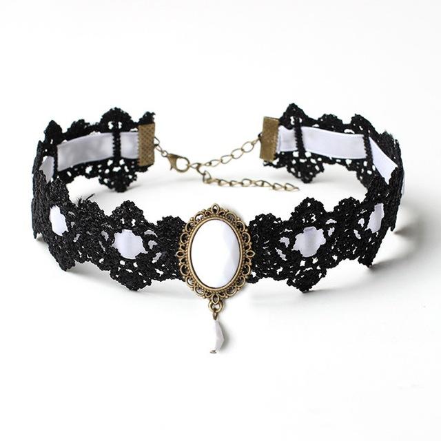 Black lace choker with an ornate oval centerpiece and hanging teardrop in the White ribbon and jewel option.