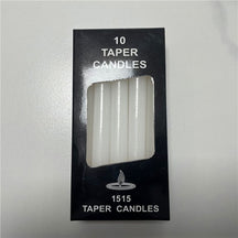 White ritual candles with their packaging, showing slim cylindrical shapes and exposed wicks.