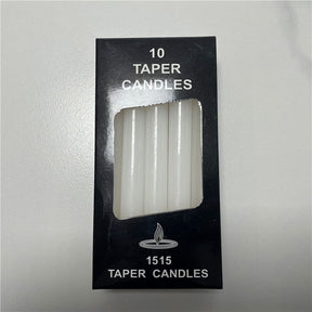 White ritual candles with their packaging, showing slim cylindrical shapes and exposed wicks.