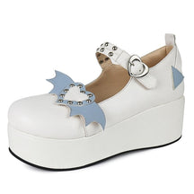 White Winged Heart platform shoe with pale blue accents, a rounded toe and heart-shaped buckle, photographed against white.