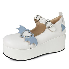 White Winged Heart platform shoe with pale blue accents, a rounded toe and heart-shaped buckle, photographed against white.