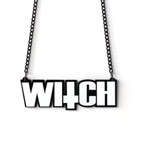 Black and white acrylic WITCH lettering necklace on a black chain, with an inverted-cross shape incorporated into the word.