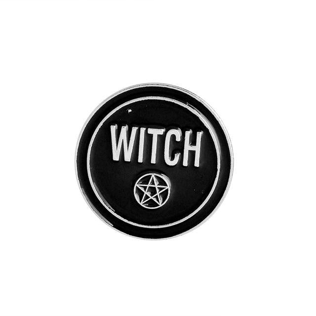 Black enamel pin spelling Witch in silver-tone letters, with a small pentacle incorporated into the design.