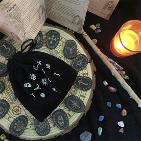 Rune pouch beside candles and books