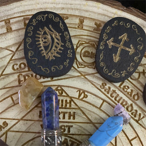Eye and crossed-symbol rune tile details