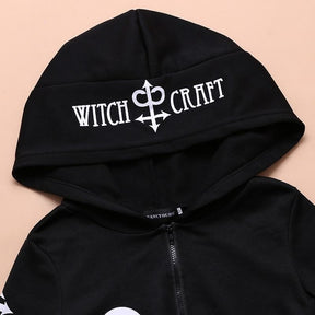 Detail of the black hood with Witch Craft lettering and a white printed symbol.