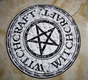 Round witchcraft rug on a tiled floor, with a pale beige print and large dark star at the centre.
