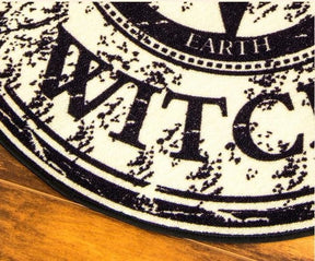 Close-up of the rug's dark bound edge beside the black-and-beige printed design.