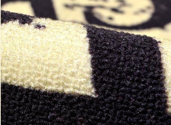 Bent section of the witchcraft rug showing the textured pile and printed surface at close range.