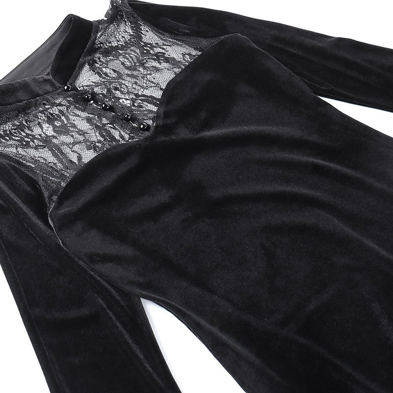 Close view of the gown laid flat, showing the curved velvet bodice edge beneath sheer floral lace.