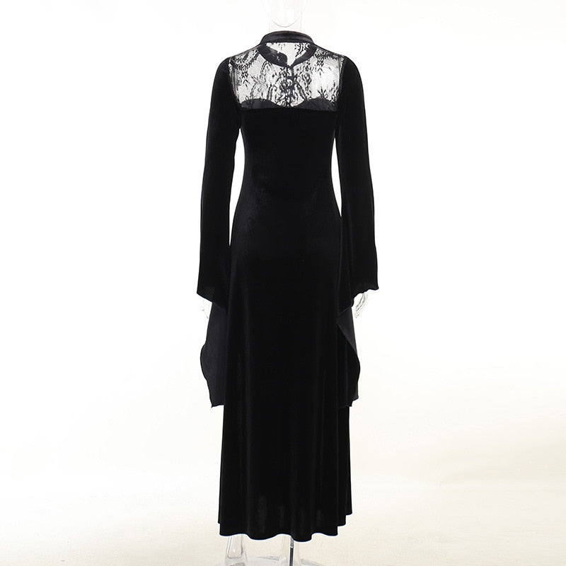Rear mannequin view with sheer lace across the upper back, a high collar and a long black velvet skirt.