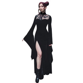 The Witching gown worn against a plain background, with one leg through the slit and one sleeve extended.