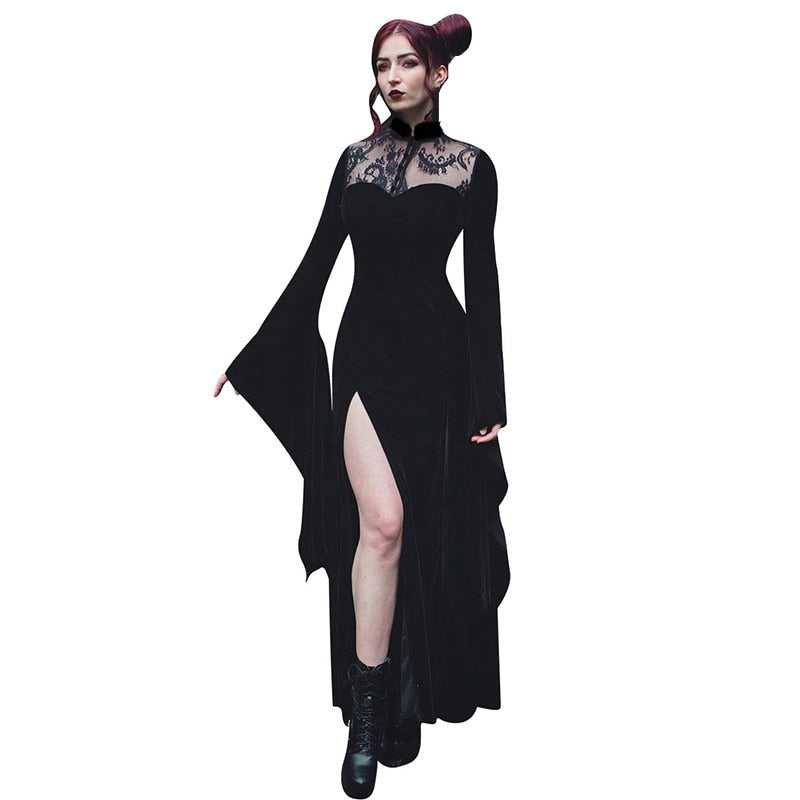 The Witching gown worn against a plain background, with one leg through the slit and one sleeve extended.
