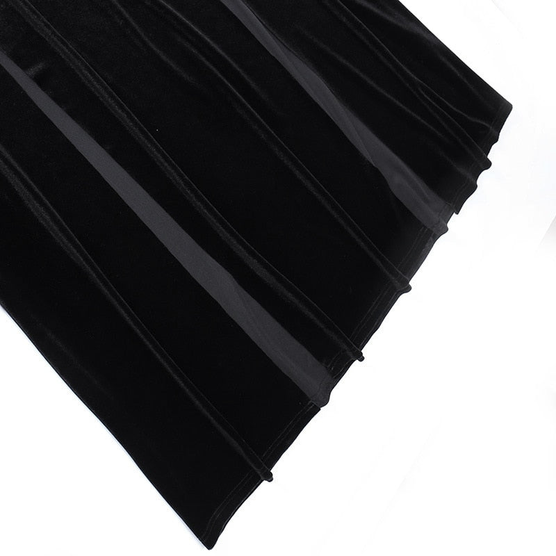 The black velvet skirt spread out to show its flared lower shape and flowing folds.