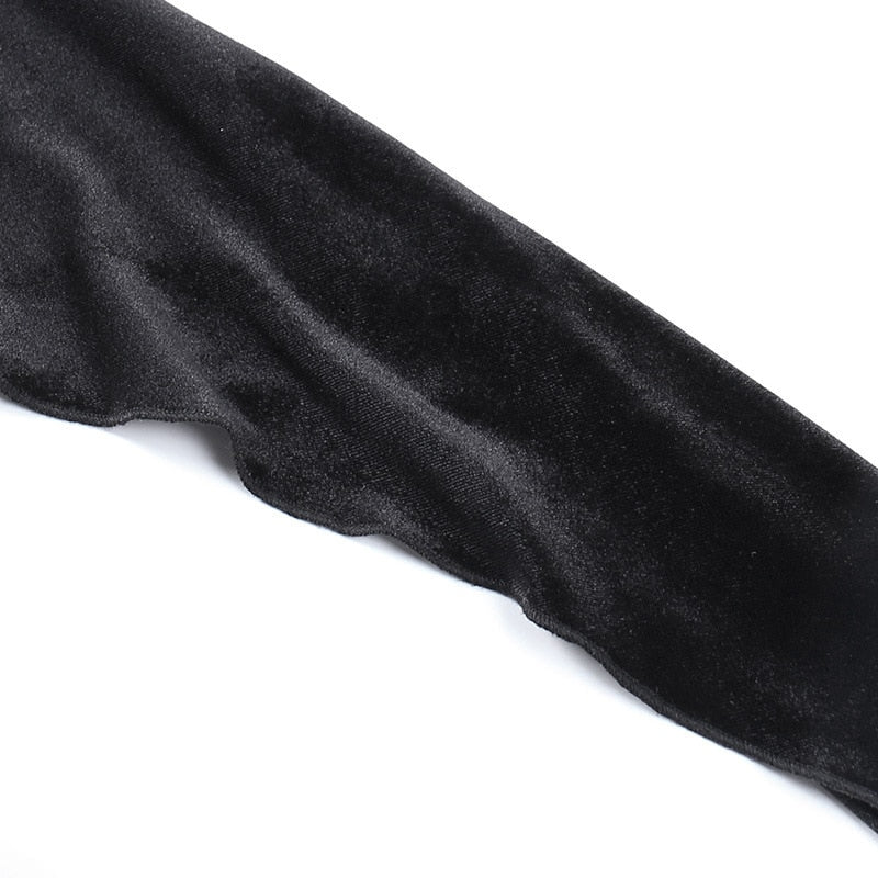 Close view of a long black velvet sleeve laid flat, showing its fitted upper section and widening lower shape.