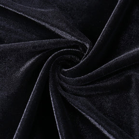 Black velvet gathered into folds, showing the gown fabric's directional sheen.