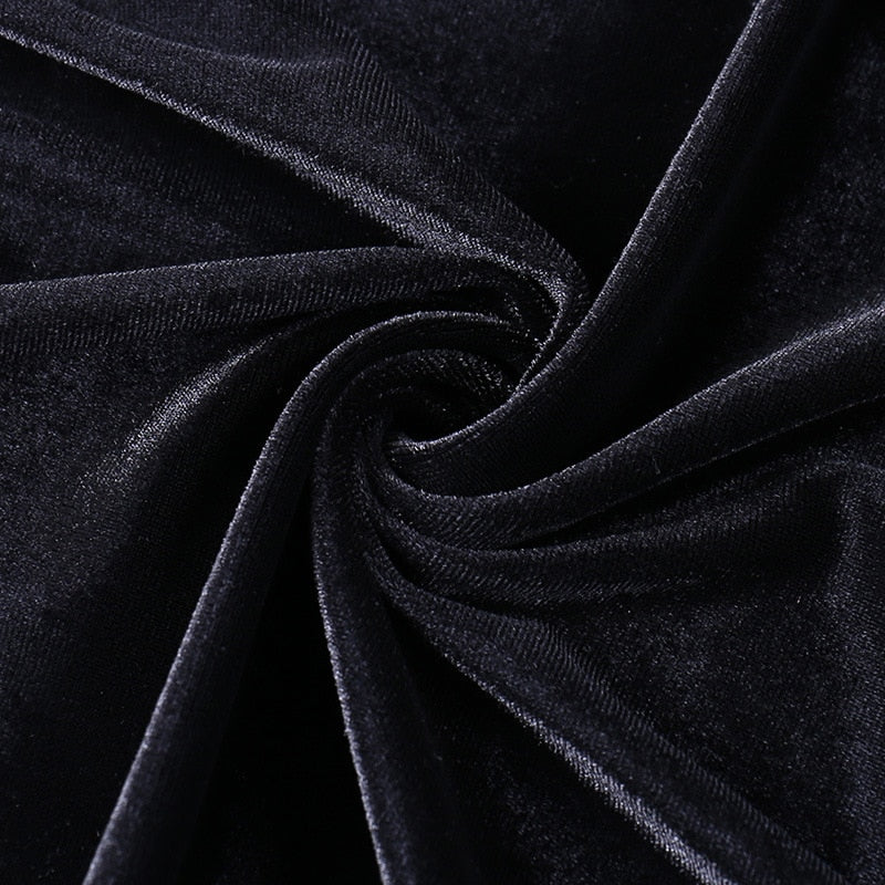 Black velvet gathered into folds, showing the gown fabric's directional sheen.