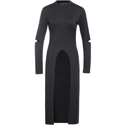 Plain black long-sleeve layering dress displayed alone against a pale background, with a high curved front opening, long back hem and small elbow cutouts.
