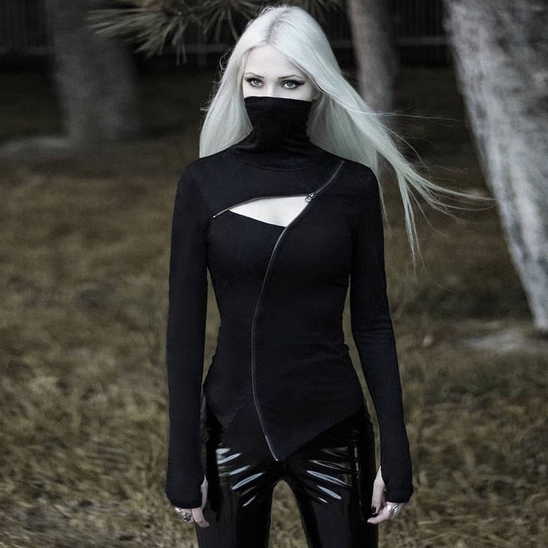 Witchy Ninja top shown standing outdoors with the collar raised and arms lowered, revealing the long sleeve cuffs and uneven pointed hem.