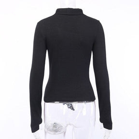Rear mannequin view of the black long-sleeve turtleneck, showing its plain fitted back and high collar.
